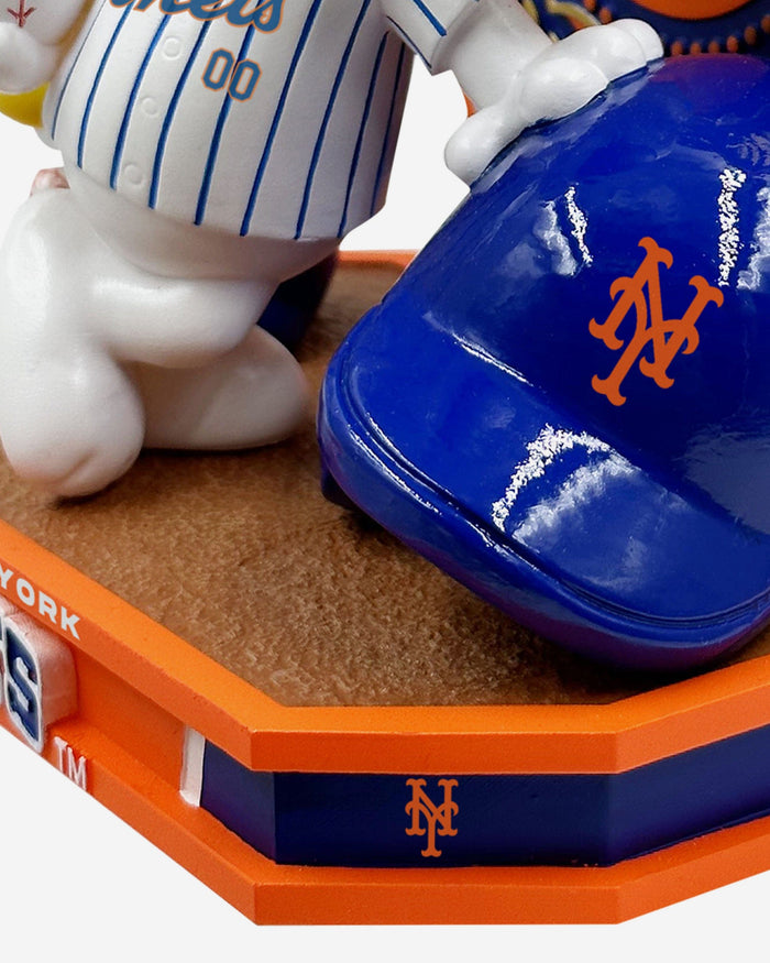 Snoopy is playing for Mets or Yankees  in bobblehead form